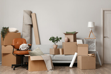 Furniture with cardboard boxes in room on moving day