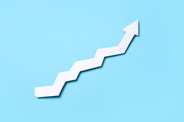 White paper arrow on blue background