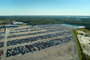 Aerial view of auction reseller company big parking lot with parked cars ready for remarketing services. Sales of secondhand vehicles
