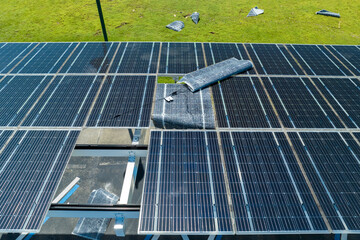 Destroyed by hurricane wind solar panels installed over parking lot canopy shade for parked cars...