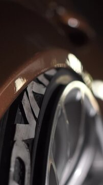 A car standing on night city street and lowers the air suspension machine to the lower position. Footage. Focusing on the wheels of a car. Sport tuning car. Close-up.