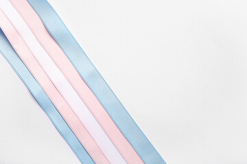 Ribbons in colors of transgender flag on white background