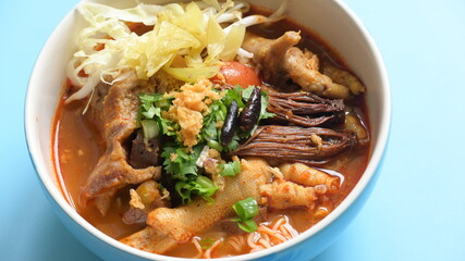 rice vermicelli with northern thai curry sauce on blue background