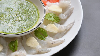 shrimp in fish sauce with Thai spicy seafood dipping sauce on white plate