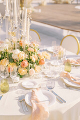 Knotted napkins lie with menus on plates on a festive table