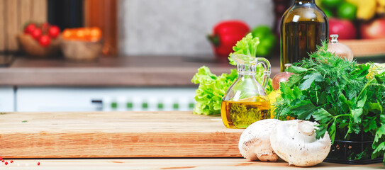 Food background. Healthy vegan eating, cooking, blogging banner scene with organic vegetables from farm market. Oak cutting board with mushrooms, spices, lettuce, olive oil and wine bottle