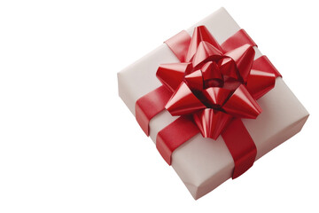 Obraz premium A luxurious gift elegantly wrapped in white with a vibrant red bow perfect for any special occasion against a black