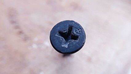 Close-up macro shot of a black screw head.  Perfect for industrial, construction, or DIY projects.