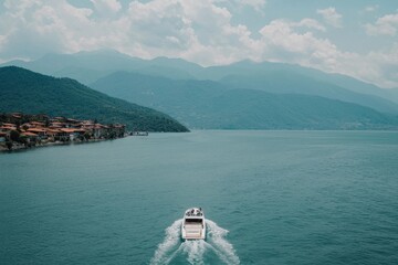 Obraz premium Scenic View of a Boat Sailing on Calm Water with Mountains in Background