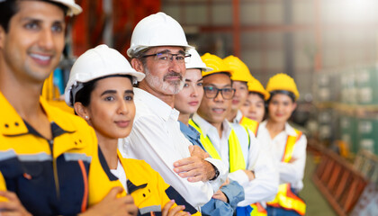 Obraz premium Unity and teamwork concept. team standing hands together. Professional Mechanical Engineer team Working at metal sheet profiling factory. Industrial production