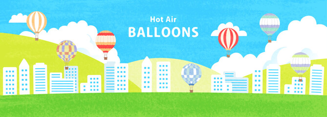 気球が飛ぶ街並みのイラスト © cocirael