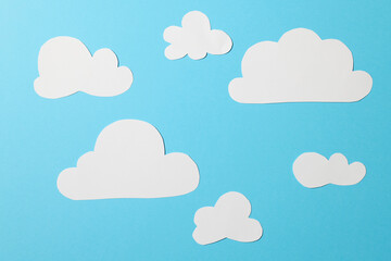 white paper clouds on blue background
