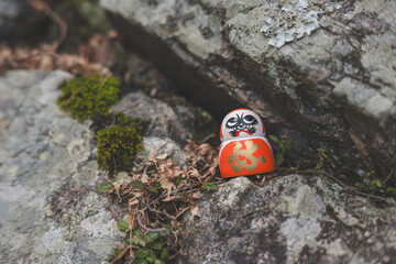 Daruma dolls, a traditional Japanese wishing doll, with the prominent kanji character (katsu) is...