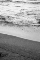 Gentle waves lap against the quiet shore at dusk