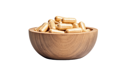 Wooden bowl filled with natural dietary supplements and herbal capsules isolated on black background
