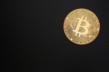 1 Golden Bitcoin coin on a black background, symbolizing digital currency and cryptocurrency. Isolated.