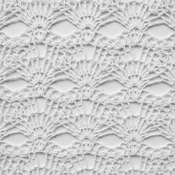 Delicate crochet pattern close up on white background