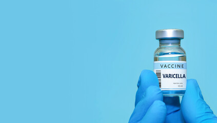 Doctor in protective gloves holding a VARICELLA vaccine . The concept of medicine, healthcare, science and vaccination awareness. Banner, copy space