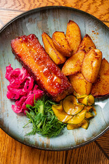 Savory meat pairs with roasted potatoes and vibrant pickled veggies, inviting a feast