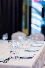 A stunning dining table with glistening glassware and pristine plates invites guests