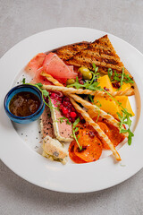 A colorful arrangement of meats, cheeses, fruits, and crispy breads, inviting a tasting adventure