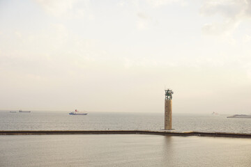 コピースペースのある風景　灯台のある夕方の海