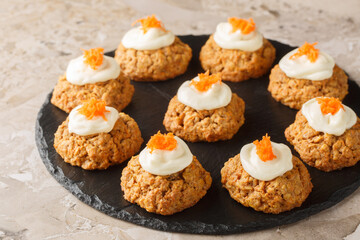 Homemade Carrot oatmeal cookie cake with cream cheese frosting close-up on plate on table. Horizontal