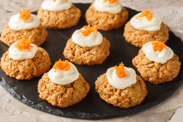 Diet gluten free carrot oatmeal cookies with cream cheese icing close-up on a plate on the table. Horizontal