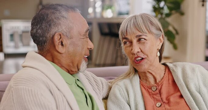 Conversation, funny and senior couple in home living room for communication, story or bonding. Elderly man, happy woman and talking on sofa for love, connection and laughing together in retirement