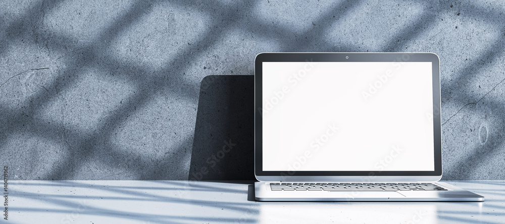 Fototapete Blank laptop screen mockup on light table with concrete wall background and shadows in modern interior setting for display or presentation template. 3D Rendering