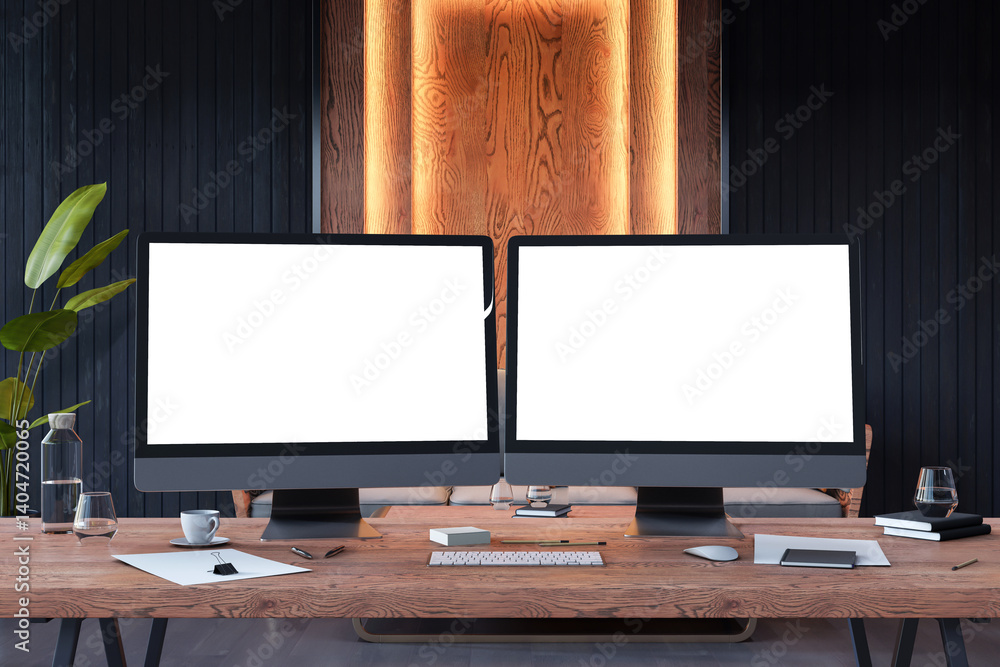 Poster dual monitor mockup on wooden workstation in backlit modern office interior with blank screens for d