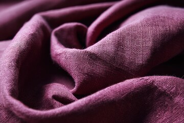 A close-up showcases the luxurious texture and rich color of draped crimson fabric, inviting touch and hinting at elegance.