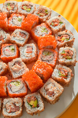  a chef in a restaurant prepares delicious Japanese sushi and rolls