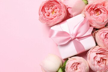 Beautiful pink peony roses with gift box on color background
