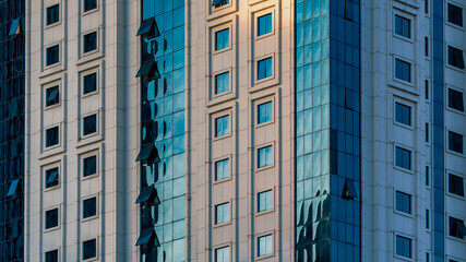 Fototapeta premium many windows and walls facade of a modern skyscraper without people