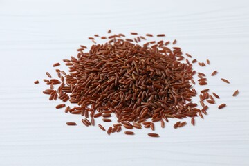 Raw brown rice on white background