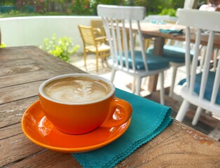 Cup of aromatic cappuccino on a table in a cafe