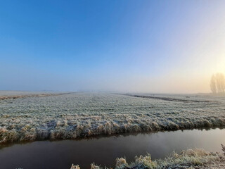 Frozen fields in fog in the Zuidplaspolder where village Cortelande will arise