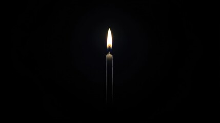 Fototapeta premium A single candle in the dark.