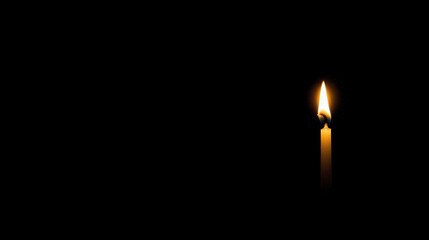 Fototapeta premium A single candle in the darkness.