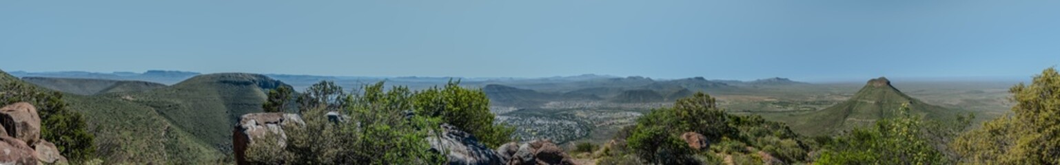 An absolutely stunning panoramic view showcasing beautiful lush valleys and distant hills beneath a...