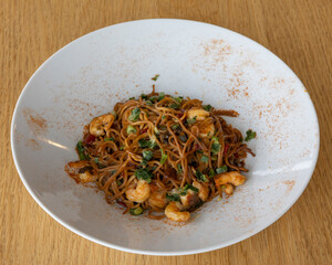 Spicy shrimp spaghetti with tomato sauce and fresh herbs for seafood pasta visuals