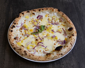White pizza with mozzarella, red onion and corn for creative Italian gourmet visuals