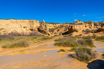 Barranco grande canyon reflecting on water in bardenas reales desert