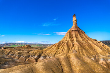 Castildetierra rock formation dominating bardenas reales desert landscape under blue sky