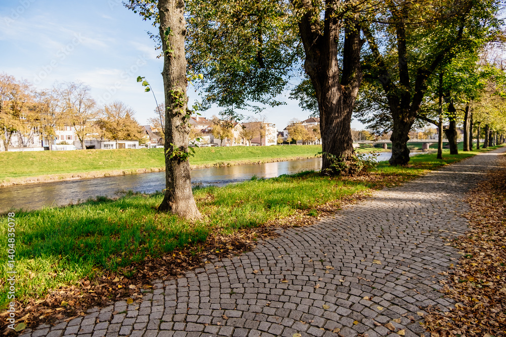Poster park with a river running through it and a path