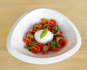Cherry tomato and mozzarella salad with pesto for Mediterranean appetizer visuals
