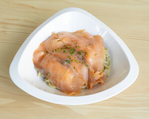 Smoked salmon on fresh tagliatelle pasta with dill for gourmet seafood meal visuals