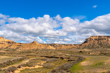 Bardenas reales desert showing eroded sandstone formations under cloudy sky