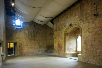 Interior of the royal palace of olite showing restored walls and fabric ceiling